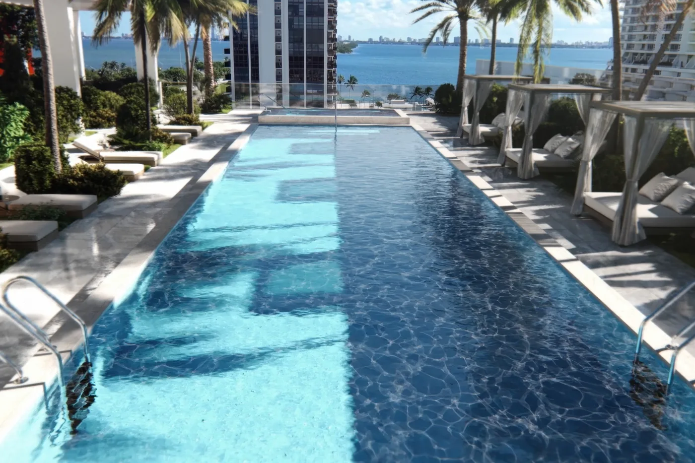 Aerial view of the VIDA rooftop pool deck against the Miami skyline at dusk